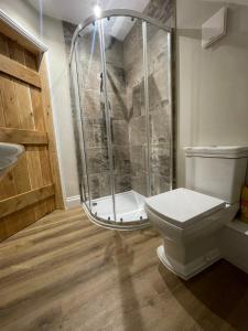 a bathroom with a shower and a toilet at Roseberry Barn, Bullamoor, Northallerton, North Yorkshire in Brompton