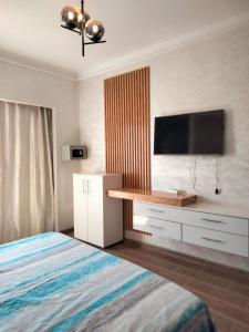 a bedroom with a bed and a desk with a television at Appart vacances marina in Agadir