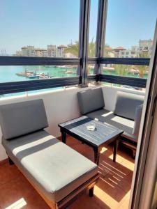 a room with two chairs and a table and a large window at Appart vacances marina in Agadir