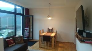 a living room with a table and a couch at Semmering Studio-Apartment in Semmering