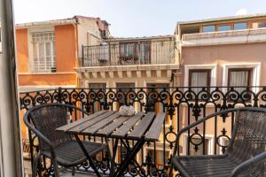 a wooden table and chairs on a balcony at 5 Apartment Galata in Istanbul