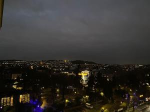 a view of a city at night with lights at Appartement entier 3 pieces. in Argenteuil