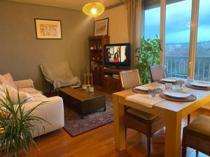 a living room with a table and a couch at Appartement entier 3 pieces. in Argenteuil