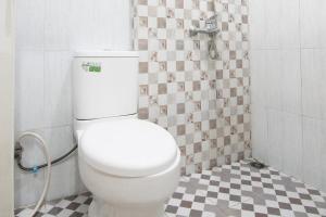 y baño con ducha y aseo blanco. en OYO 93457 White House Syariah, en Kubang