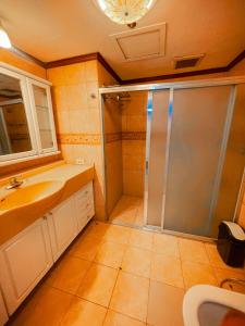 a bathroom with a shower and a sink at Spacious Luxury 3BR at the Heart of Makati in Manila