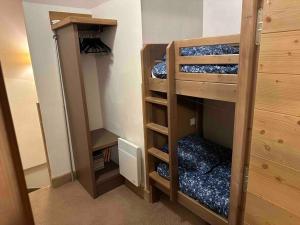 a room with two bunk beds in a room at Risoul duplex 48m2 avec piscine et sauna in Risoul +13 photos