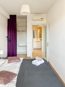 a bedroom with two beds and purple curtains at Garden Apartment - Herastrau Park 3min Walk in Bucharest