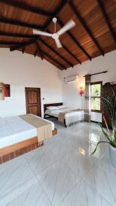 a bedroom with two beds and a ceiling fan at The lookout lodge in Tangalle