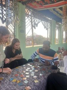 a group of people sitting around a table playing a game at Hotel Poonam Pushkar in Pushkar