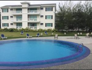 a large swimming pool in front of a building at Home Feel-Camellia Suites in Kampar