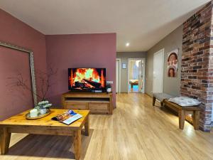 a living room with a fireplace and a tv at Silversmith's Residence in Old Riga in Riga