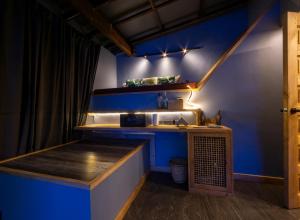 a bar in a room with a blue wall at Rockinnest Hotel El Nido in El Nido