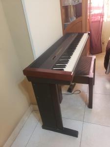 a brown and white piano sitting in a room at Family Friendly Appartement-Giza in Cairo