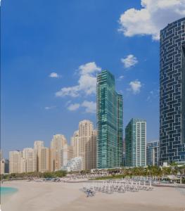 a view of a city skyline with tall buildings at Stunning 5* 4BR-Oceanfront-Apartment in Dubai