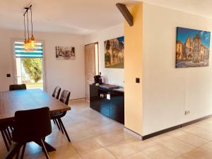 a dining room and kitchen with a table and chairs at 3-Bedroom Holiday Home with Aircon and Private heated plunge Pool - 5 Minutes from Monpazier in Capdrot