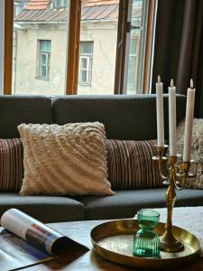 a table with candles on top of a couch at Silversmith's Residence in Old Riga in Riga