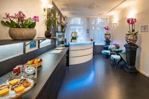 a lobby of a hotel with a counter with food at Jupiter Hotel in Amsterdam