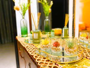 a table topped with glasses with flowers in them at Cosy greeny near PAUL harhoura in El Harhoura