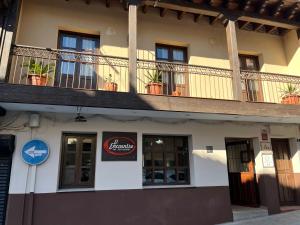 a building with a balcony on top of it at APARTAMENTOS RURAL LA JACOBA in Cabezuela del Valle