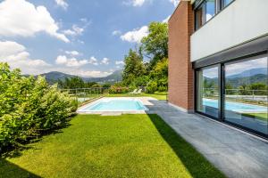 a swimming pool in the backyard of a house at Villa Girandola with private, heated pool in Lugano