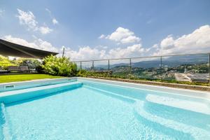 a swimming pool on the roof of a house at Villa Girandola with private, heated pool in Lugano