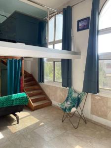a bedroom with a bunk bed and two chairs at Studio cosy sur la corniche in Dakar