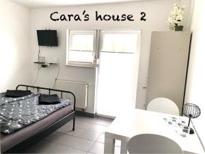 a room with a bed and a sign that reads caras house at Cara's house in Ljubljana