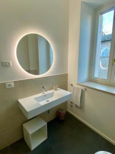 a bathroom with a white sink and a mirror at B&B Lidia Ricci in Montegiorgio
