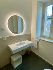 een badkamer met een witte wastafel en een spiegel bij B&B Lidia Ricci in Montegiorgio