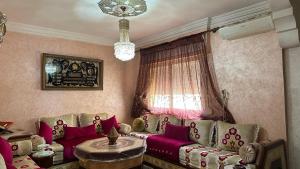 a living room with a couch and a window at appartement belle in Meknès