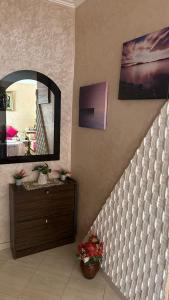 a room with a mirror and a dresser and a staircase at appartement belle in Meknès