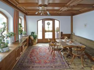 a dining room with a table and chairs and a rug at Haus Paznaun in Kappl