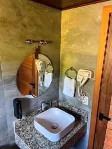 uma casa de banho com um lavatório e um espelho em Chalé Villa Felicitá (Itália) em Pomerode