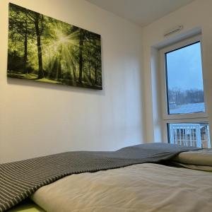 a bedroom with a bed with a picture on the wall at Ferienwohnung Auf Der Höll 
