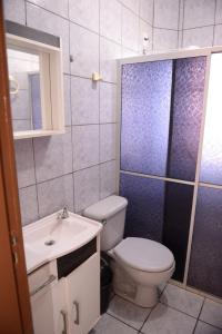 a bathroom with a toilet and a sink and a shower at Incrivel apto completo e confortavel Santa Rosa RS in Santa Rosa