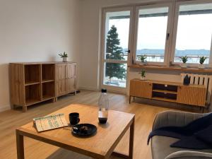 a living room with a bottle of wine on a table at P15 in Suwałki