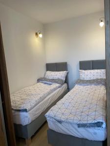 two twin beds in a room with at P15 in Suwałki