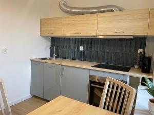 a kitchen with wooden cabinets and a wooden table at P15 in Suwałki