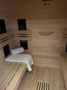 a sauna with two towels sitting on a wooden floor at Wellness Tajemství Lucy 