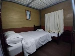 Postel nebo postele na pokoji v ubytování Cabaña La Guitarra