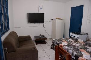 a living room with a couch and a flat screen tv at Apto c Wifi e otima localizacao em Santa Rosa RS in Santa Rosa