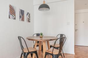 a dining room table with chairs and a pendant light at Fliphaus Melo 2900 - 1 Bd Alto Palermo in Buenos Aires