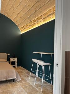 a bedroom with a bed and a table and stool at Aqua - Letto e Colazione in Acquaviva delle Fonti