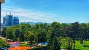 a view of a park with trees and a building at Parkpoint in Banja Luka