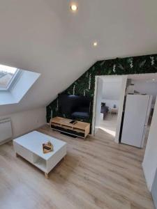 a living room with a couch and a table at Cosy appartement proche Disneyland in Étampes-sur-Marne