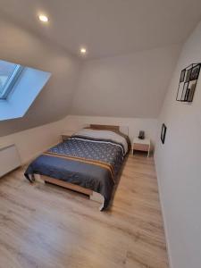 a bedroom with a bed in a room with a window at Cosy appartement proche Disneyland in Étampes-sur-Marne