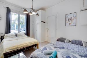 a bedroom with two beds and a window at Smart apart in Paris in Vanves