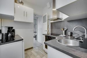 a kitchen with a sink and a counter top at Smart apart in Paris in Vanves