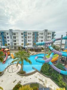 a large pool with a water slide at a resort at Astara Hotel Balikpapan in Balikpapan