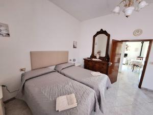 a bedroom with two beds and a mirror at CASA MARIA in Castel del Piano
